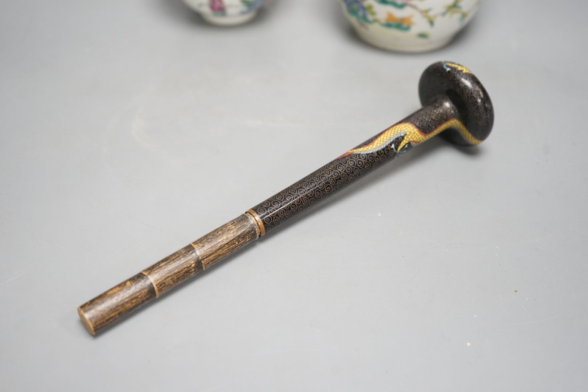 A Chinese famille rose chupu and a bowl, late 19th century, and a cloisonne parasol handle, 23cm long